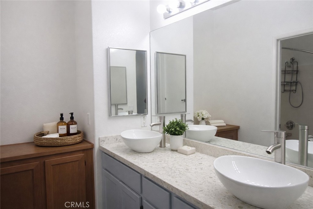 1285 Fools Gold Way, Unit 2 Chula Vista, CA 91913 - Photo 35 of 43 a bathroom with a granite countertop sink and a mirror