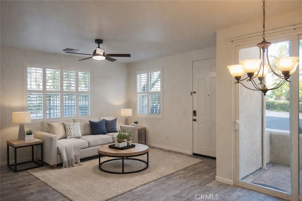 1285 Fools Gold Way, Unit 2 Chula Vista, CA 91913 - Photo 4 of 43 a living room with furniture a chandelier and a window