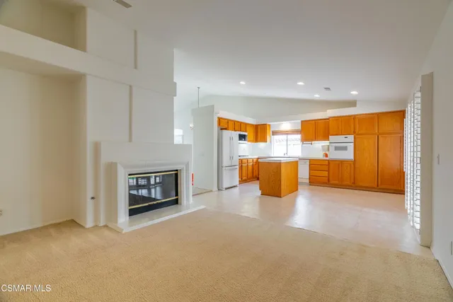 a view of a kitchen with a sink and a fireplace