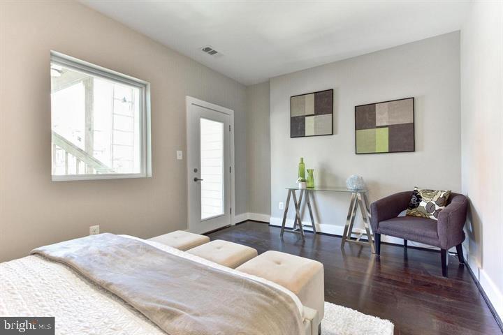 1453 Girard Street Northwest, Unit 3 Washington, DC 20009 - Photo 11 of 21 a bedroom with a bed and a chair