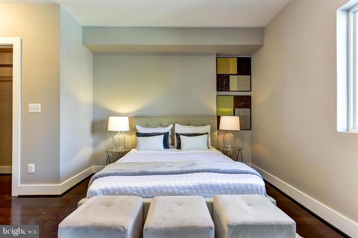 1453 Girard Street Northwest, Unit 3 Washington, DC 20009 - Photo 12 of 21 a bedroom with a bed and wooden floor