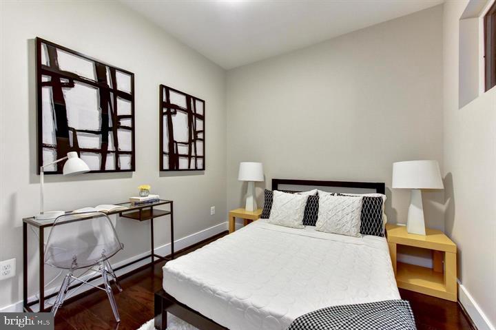 1453 Girard Street Northwest, Unit 3 Washington, DC 20009 - Photo 16 of 21 a bedroom with a bed and wooden floor