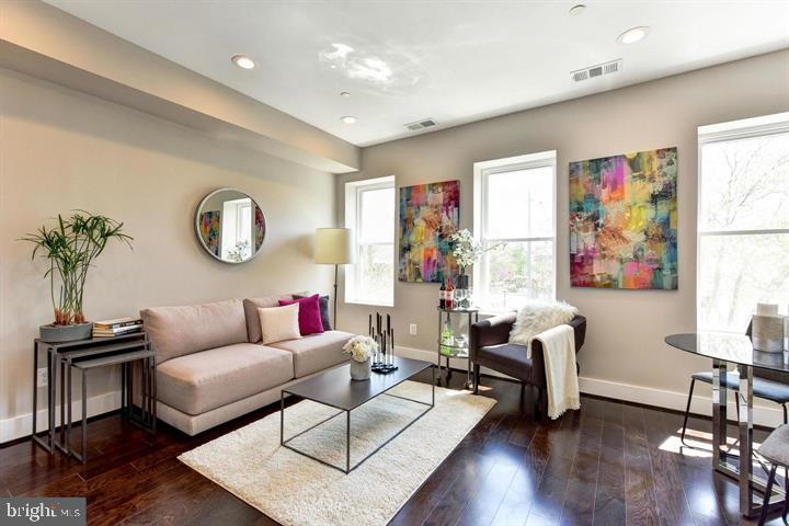 1453 Girard Street Northwest, Unit 3 Washington, DC 20009 - Photo 2 of 21 a living room with furniture and wooden floor