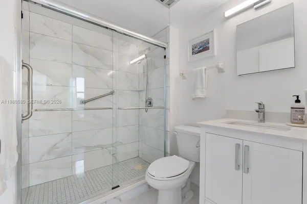 a bathroom with a sink toilet and shower