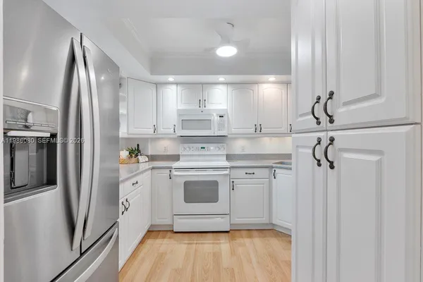 a kitchen with stainless steel appliances a refrigerator sink and cabinets
