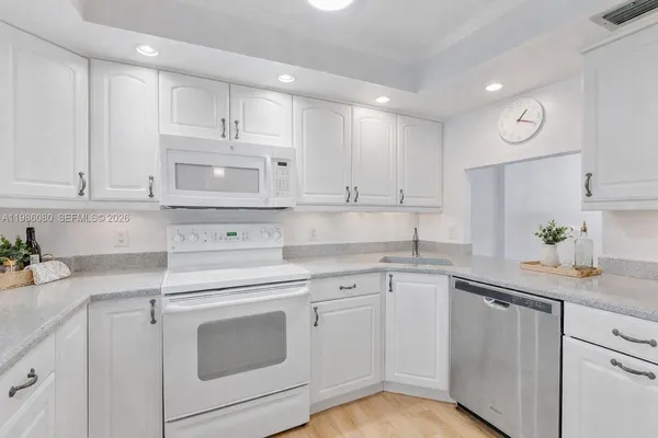 a kitchen with cabinets appliances and a counter top space