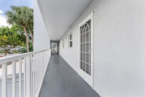 a view of staircase with railing and white walls