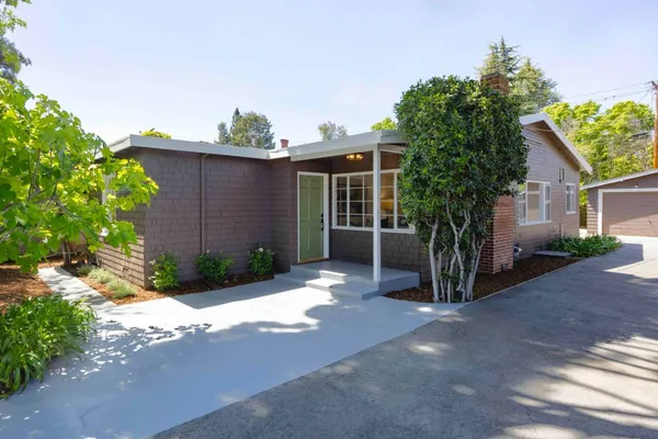 a front view of a house with a yard and a garage