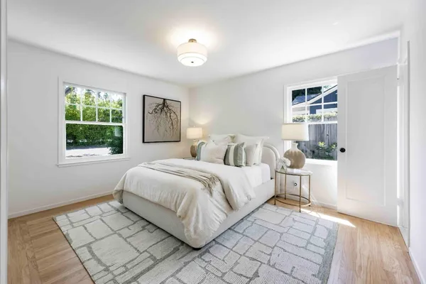 a spacious bedroom with a bed and a window