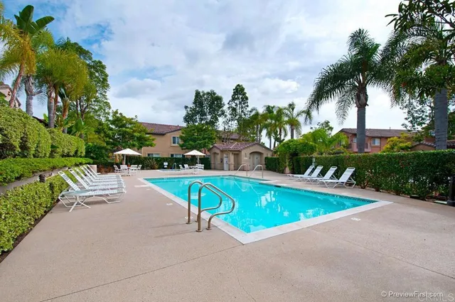 a swimming pool with outdoor seating and garden