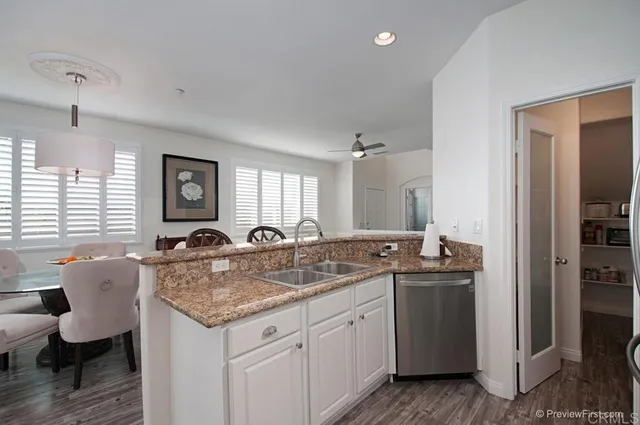 a kitchen with granite countertop kitchen island a sink appliances and a center island