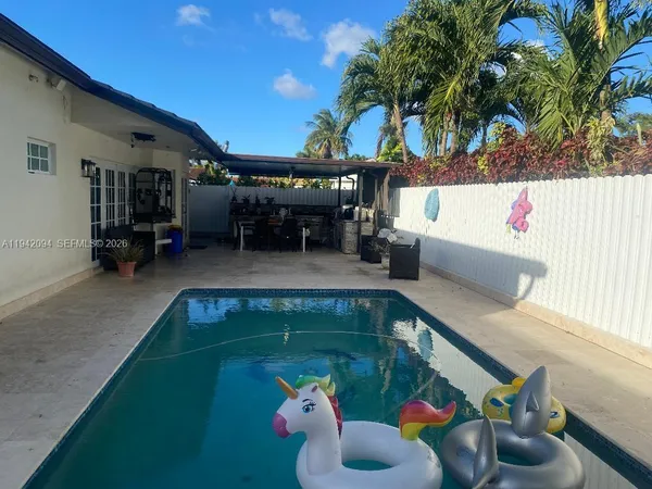 a swimming pool with outdoor seating and yard