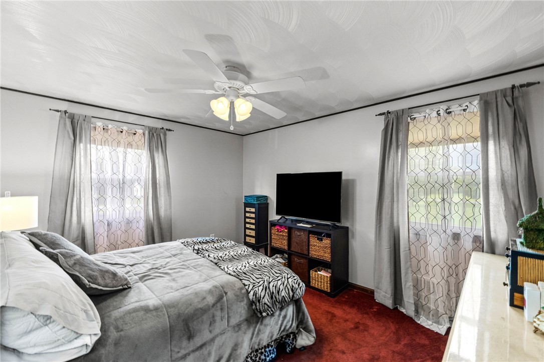1140 Willits Road Ontario, NY 14519 - Photo 14 of 50 Ceiling fan and two windows in primary bedroom.
