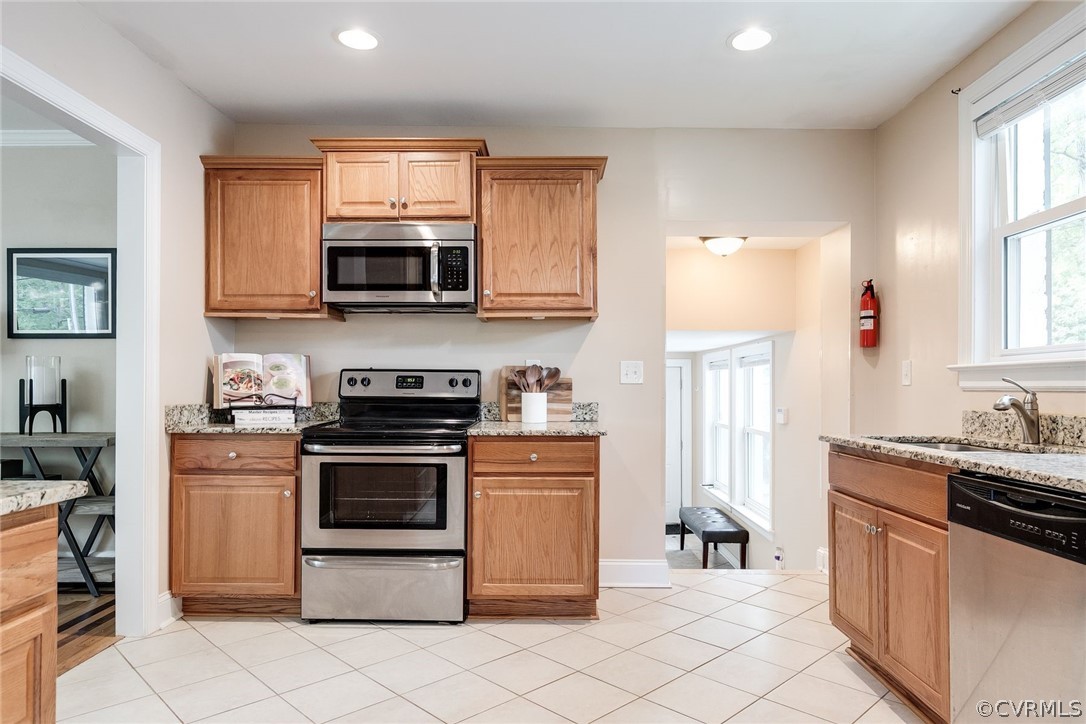 7547 Cherokee Road Richmond, VA 23225 - Photo 14 of 29 a kitchen with stainless steel appliances granite countertop a stove a sink and a microwave