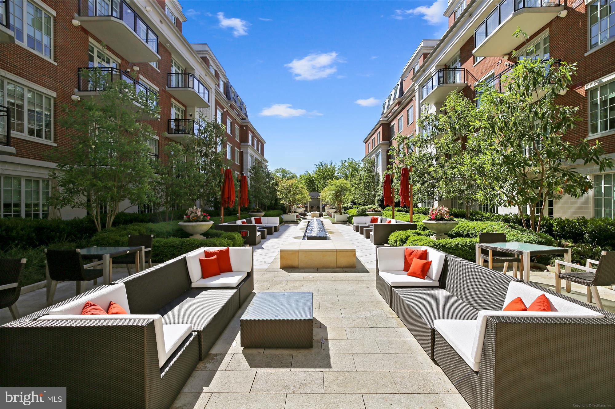 6900 Fleetwood Road, Unit 600 McLean, VA 22101 - Photo 20 of 32 a view of a patio with couches and a fire pit and a yard