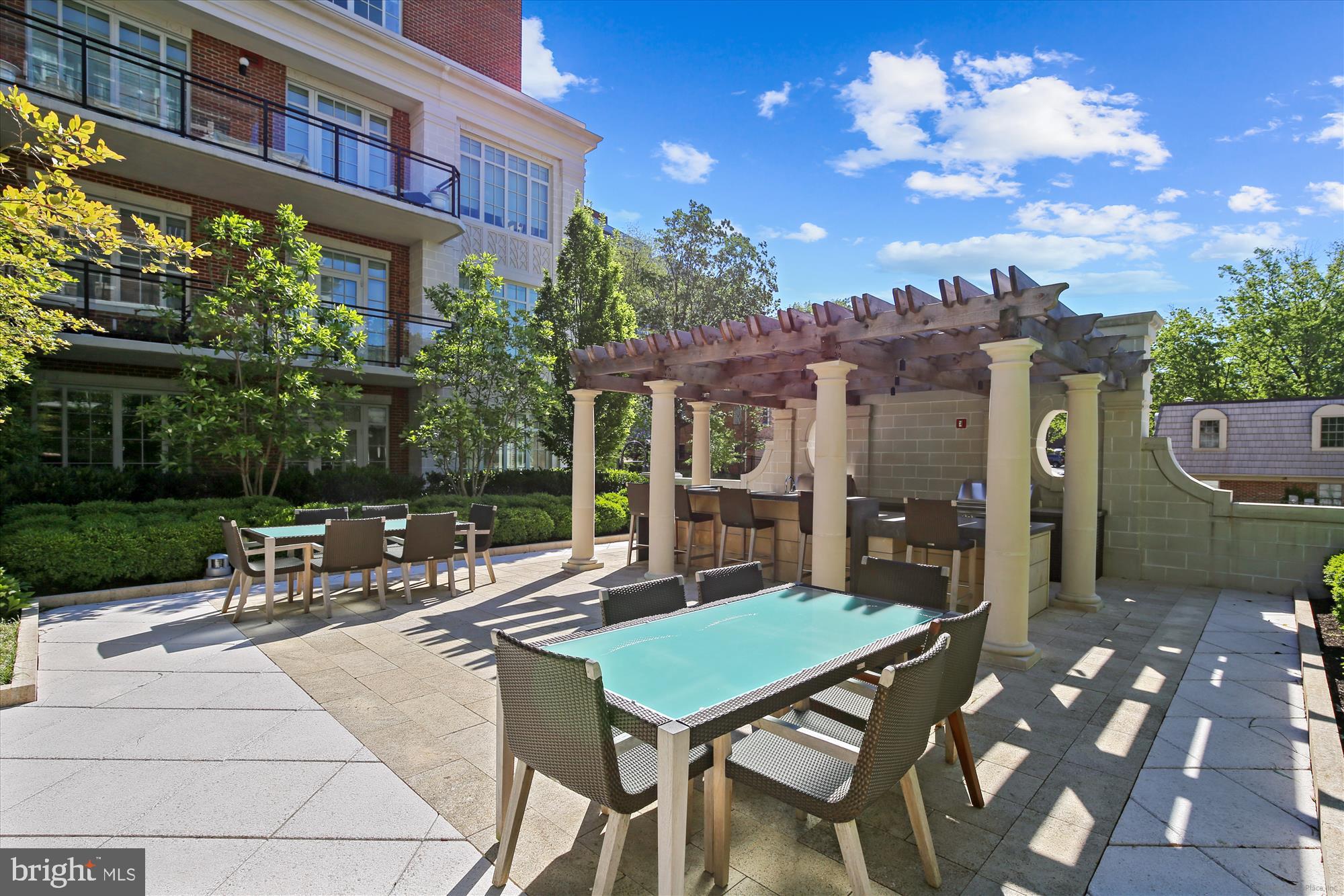 6900 Fleetwood Road, Unit 600 McLean, VA 22101 - Photo 23 of 32 a view of a patio with a table and chairs and potted plants