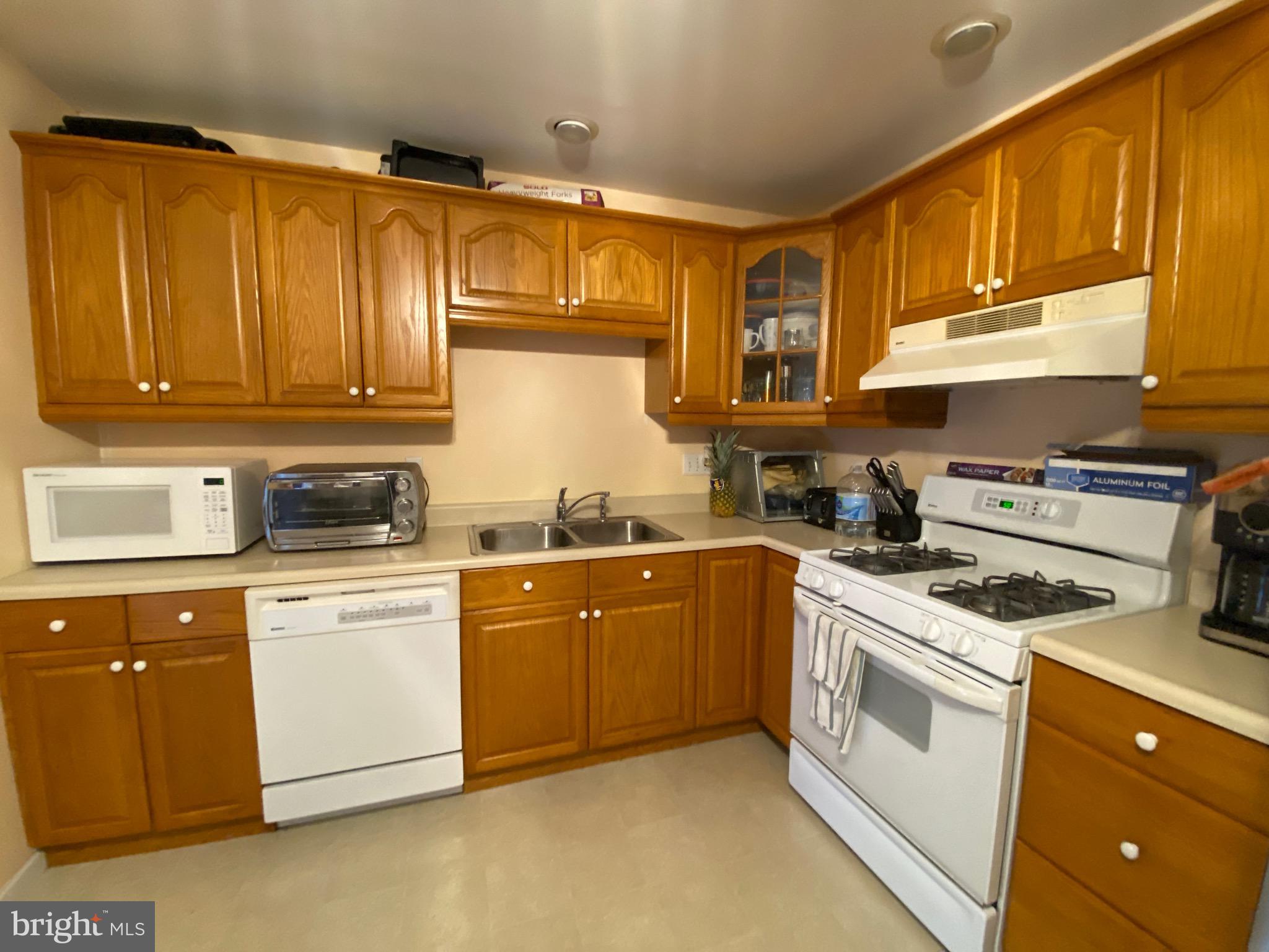 42 Harvard Road Pennsville, NJ 08070 - Photo 16 of 26 a kitchen with stainless steel appliances granite countertop a stove sink and cabinets