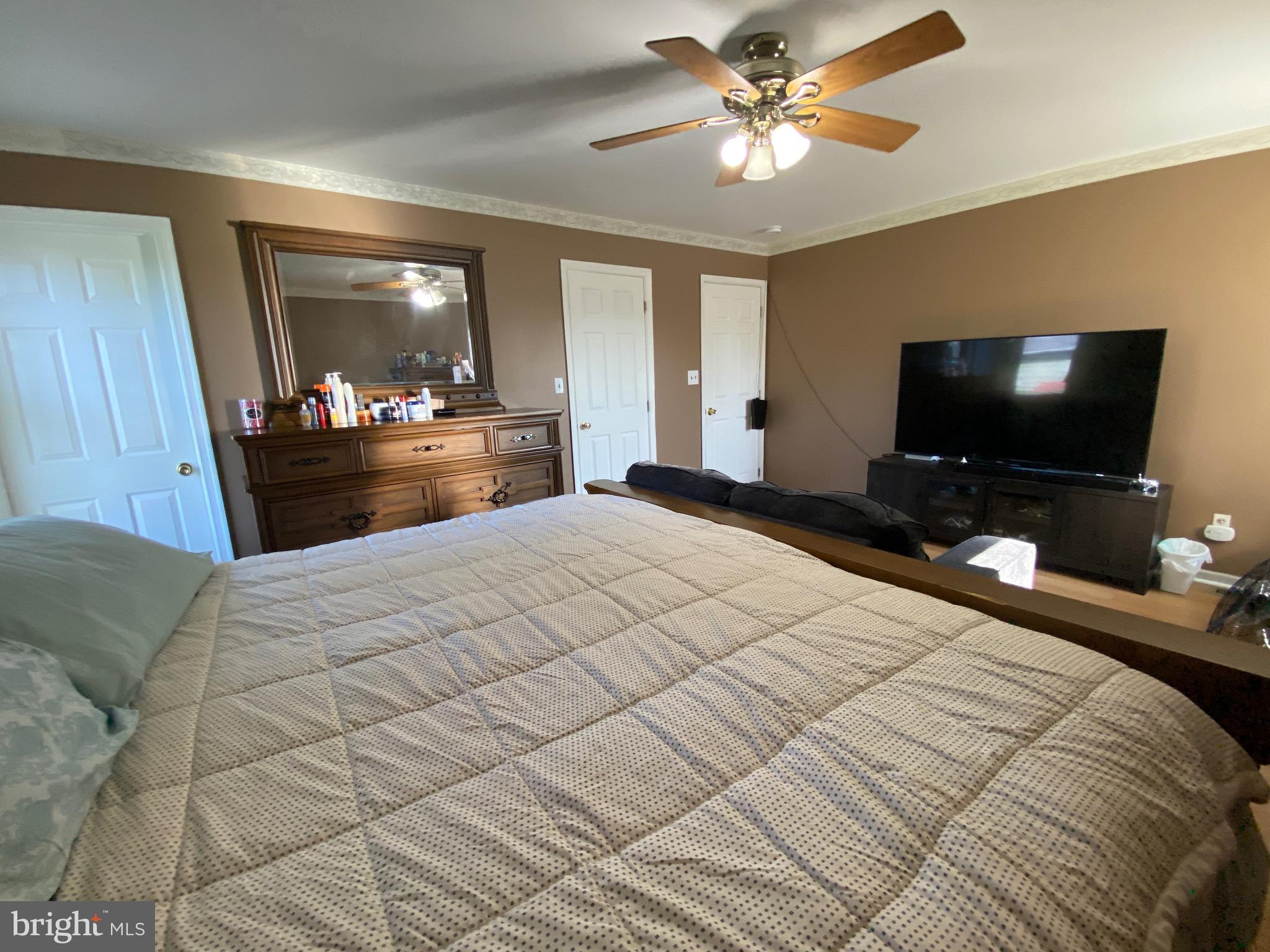 42 Harvard Road Pennsville, NJ 08070 - Photo 17 of 26 a bedroom with a bed and a flat screen tv
