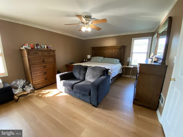 a bed room with a bed window and a ceiling fan