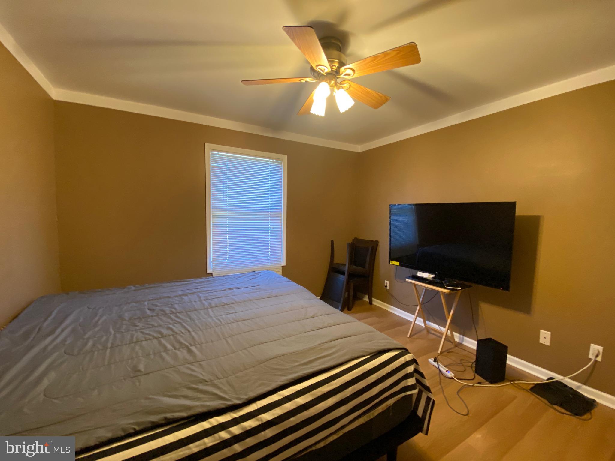 42 Harvard Road Pennsville, NJ 08070 - Photo 21 of 26 a bedroom with a bed and a flat screen tv