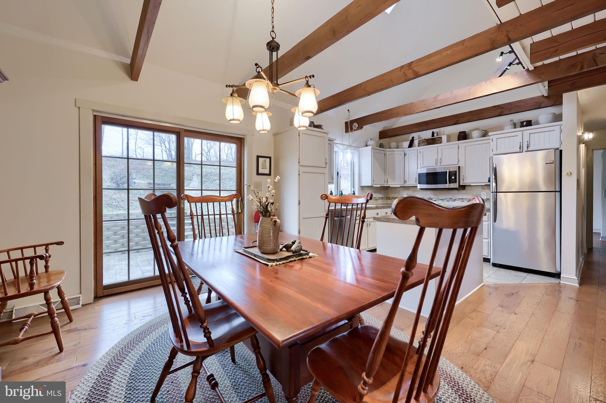 1521 West Penn Grant Road Lancaster, PA 17603 - Photo 16 of 67 a view of a dining room with furniture a chandelier and wooden floor