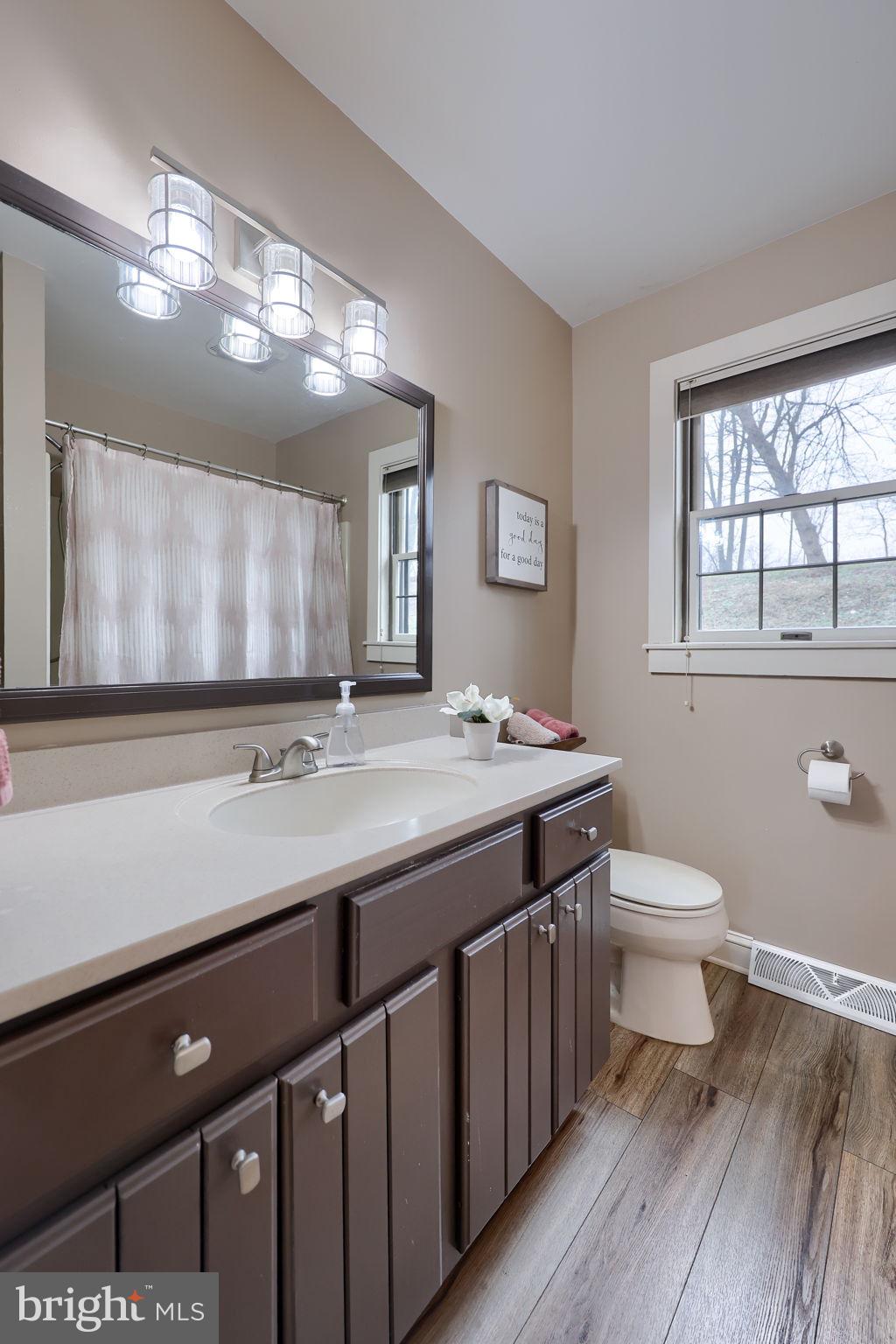 1521 West Penn Grant Road Lancaster, PA 17603 - Photo 17 of 67 a bathroom with a granite countertop sink a toilet and a mirror