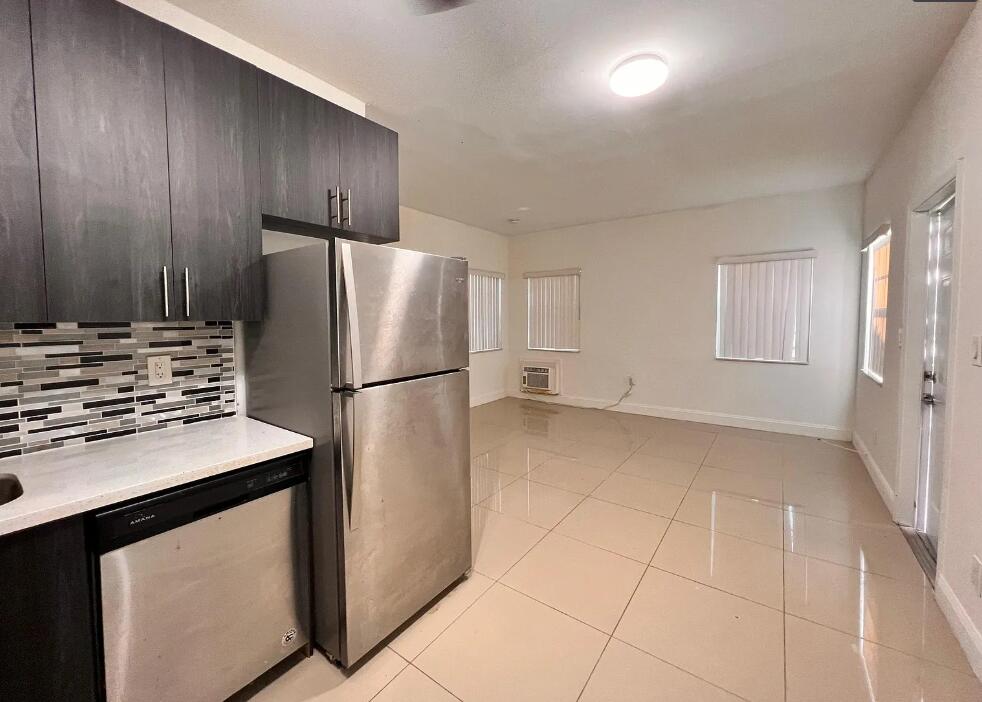 950 Lake Wyman Road, Unit A Boca Raton, FL 33431 - Photo 2 of 5 a kitchen with stainless steel appliances a refrigerator and a stove top oven