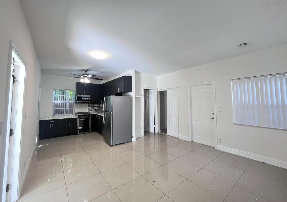 950 Lake Wyman Road, Unit A Boca Raton, FL 33431 - Photo 4 of 5 a kitchen with stainless steel appliances a refrigerator and cabinets