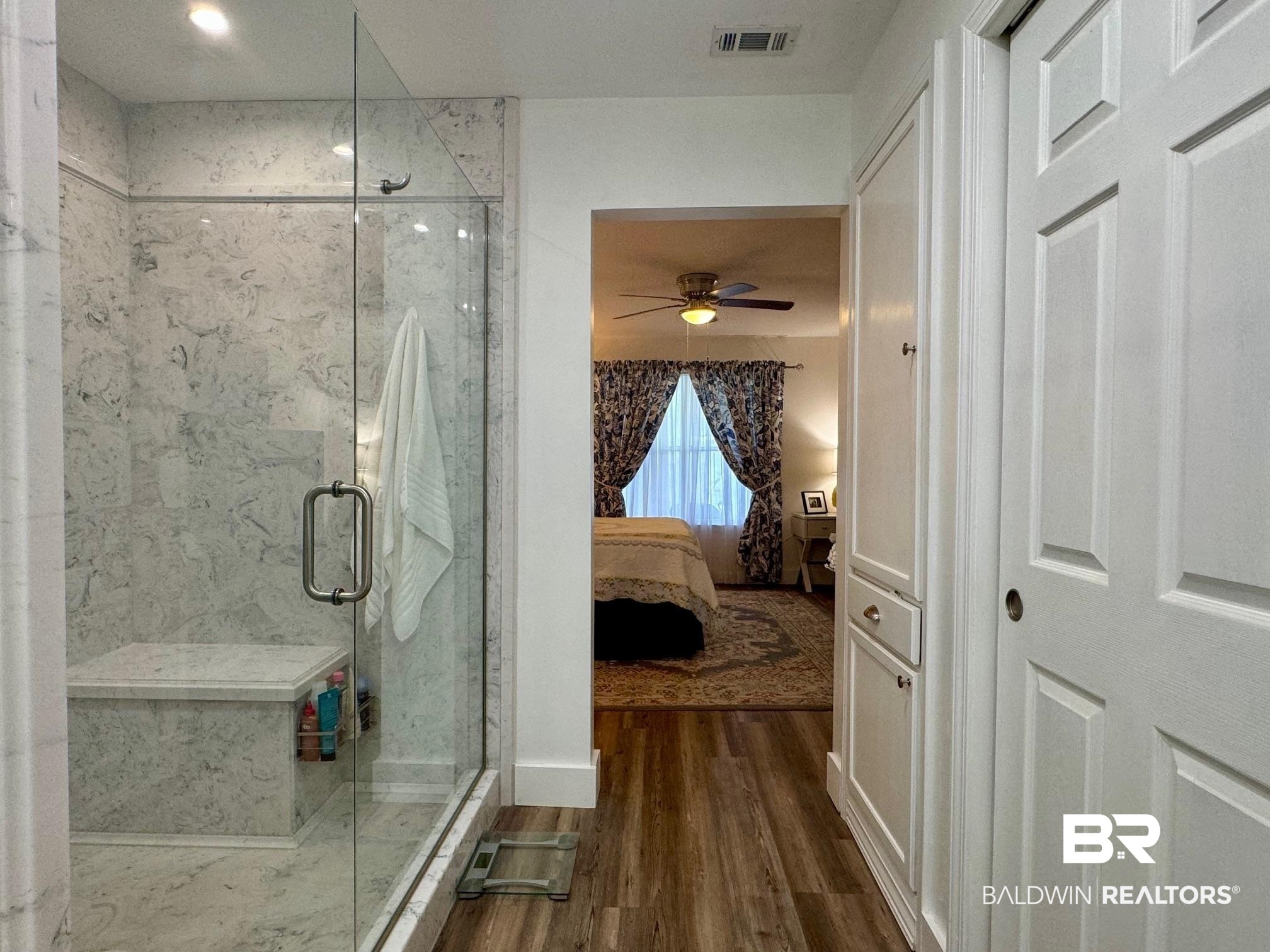 3200 Loop Road, Unit 55 Orange Beach, AL 36561 - Photo 19 of 40 Bathroom featuring ceiling fan, hardwood / wood-style flooring, and an enclosed shower