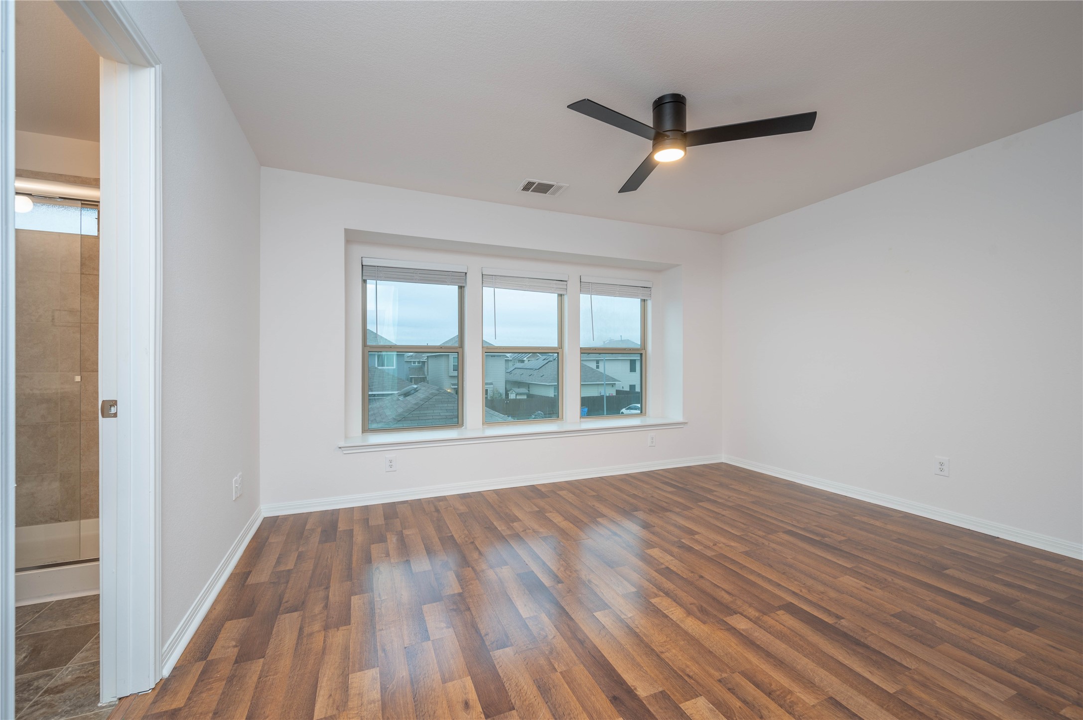 4514 Truth Way Austin, TX 78725 - Photo 15 of 20 Unfurnished room with dark hardwood / wood-style flooring and ceiling fan