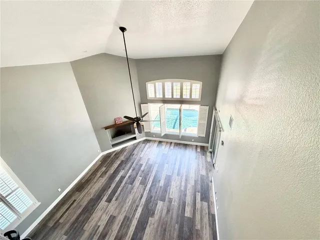 a view of hallway with wooden floor and stairs
