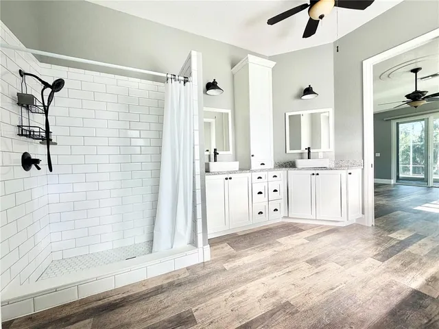 a view of a bathroom with a bathtub and a shower