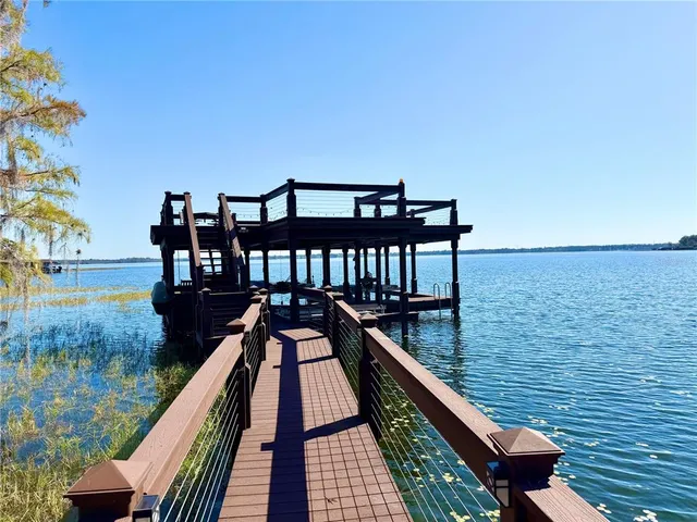a view of a balcony with chair and lake view
