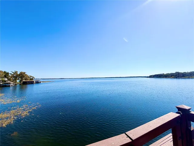 a view of a deck with table and chairs with wooden floor and fence