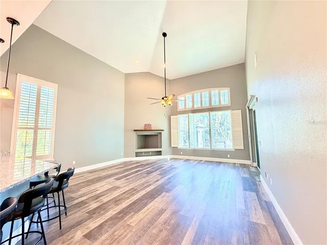 a bedroom with furniture a chandelier and wooden floor