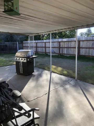 a view of a backyard with sitting area