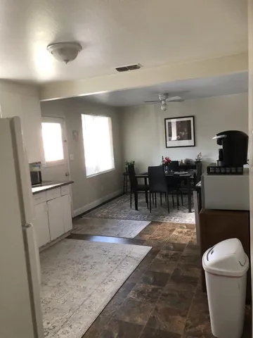 a living room with furniture a dining table and a piano table