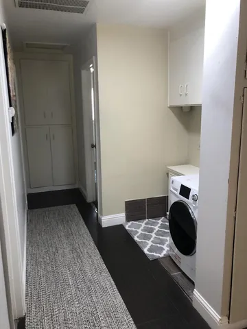 a view of hallway with washer and dryer
