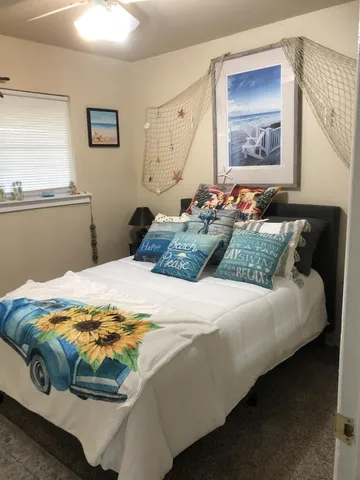 a bedroom with bed and window