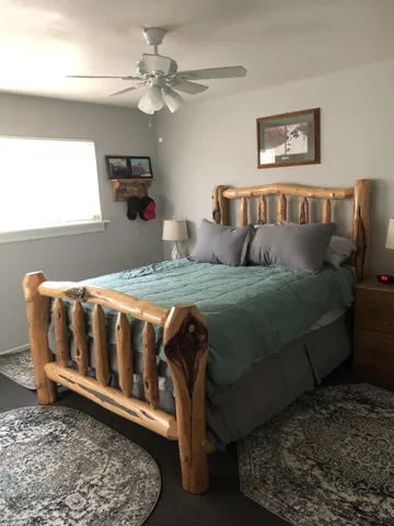 a bedroom with a bed a couch and a window