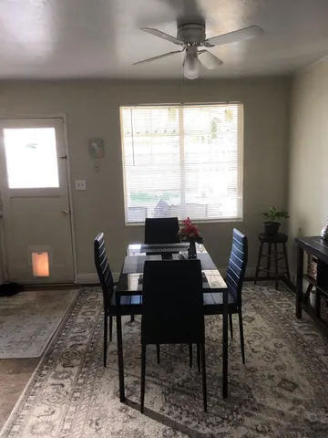a view of a dining room with furniture window and outside view