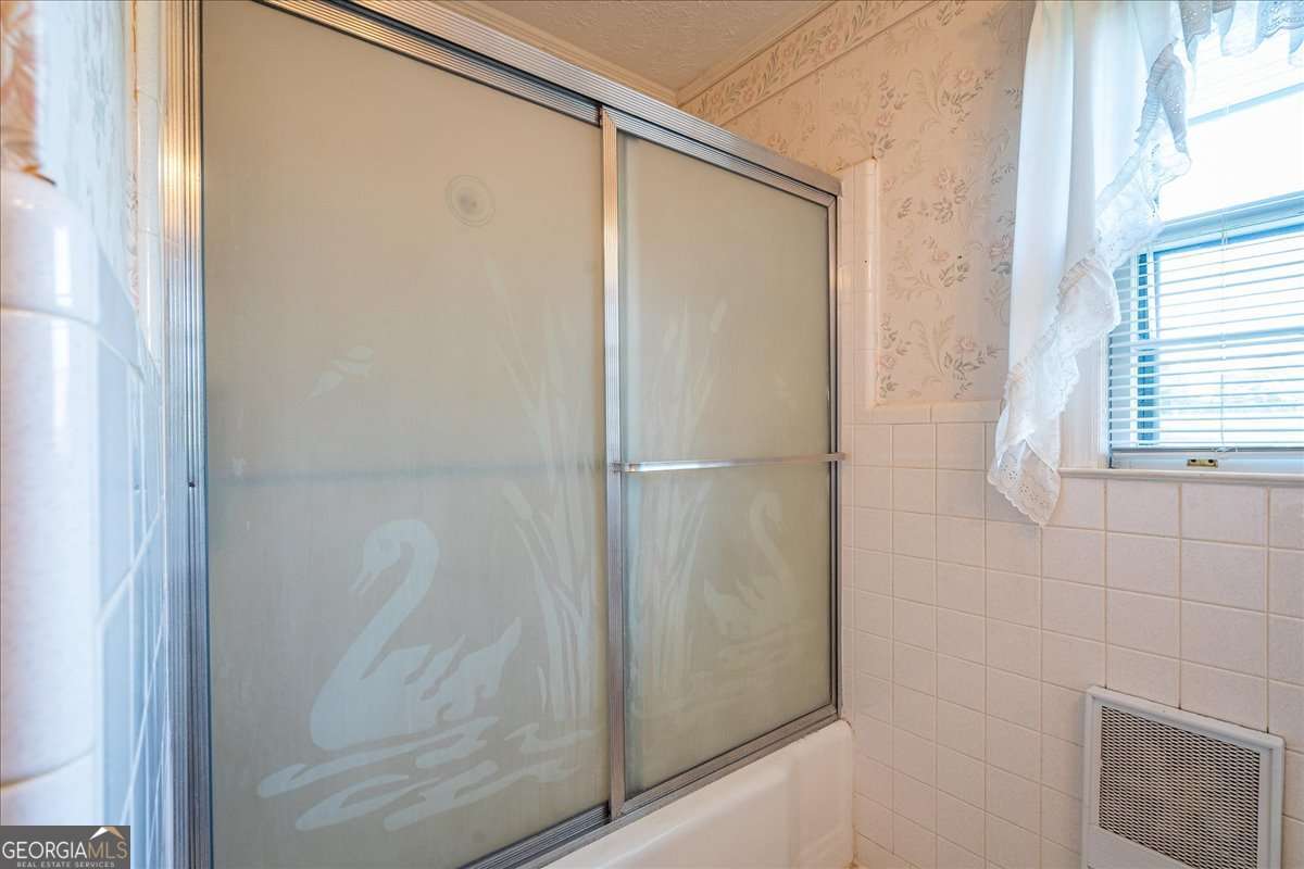 11302 Jefferson Road Athens, GA 30607 - Photo 13 of 75 a bathroom with a glass shower door