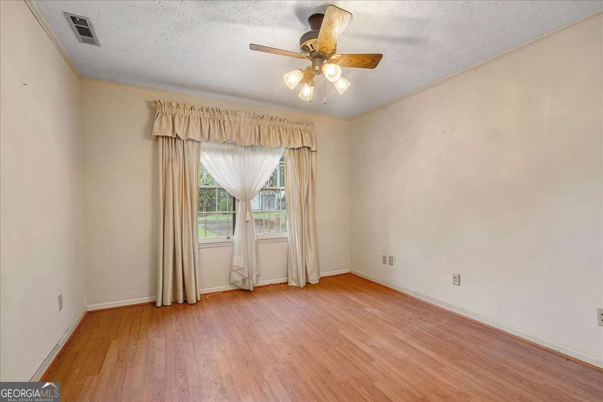 11302 Jefferson Road Athens, GA 30607 - Photo 17 of 75 an empty room with wooden floor and fan