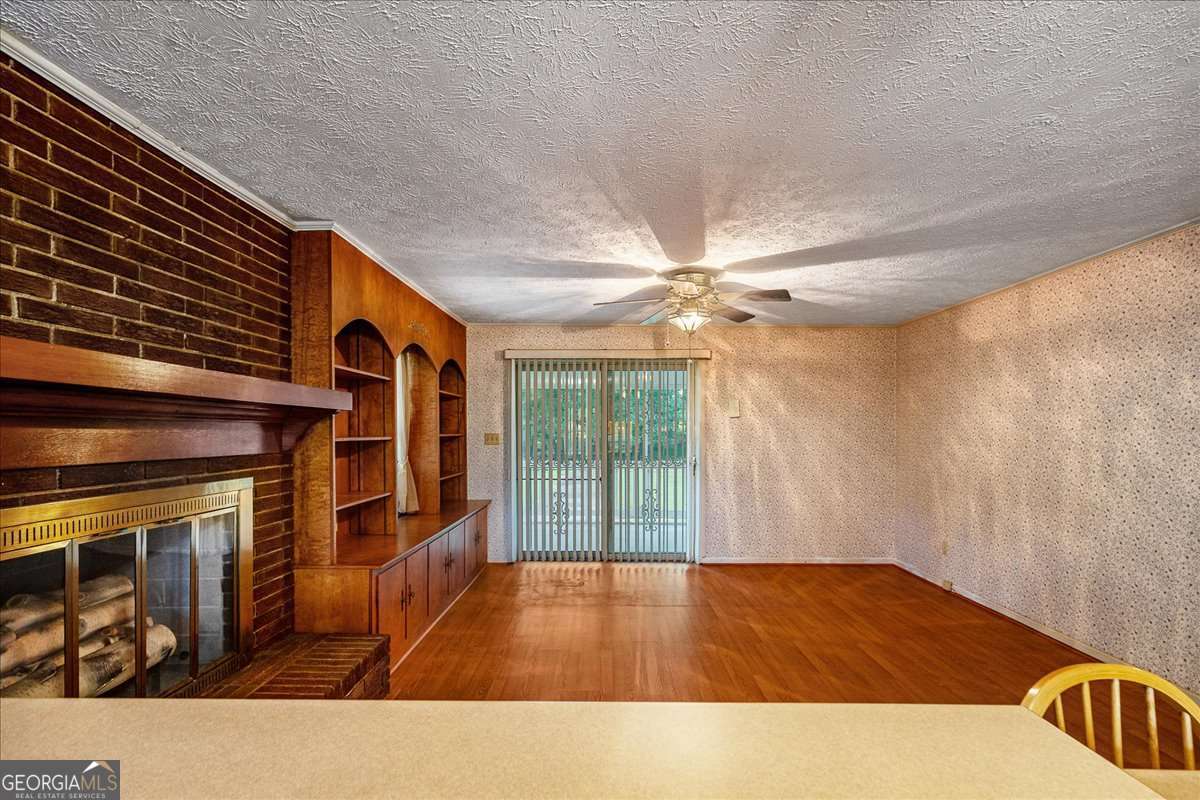11302 Jefferson Road Athens, GA 30607 - Photo 24 of 75 a view of a livingroom with wooden floor and a ceiling fan