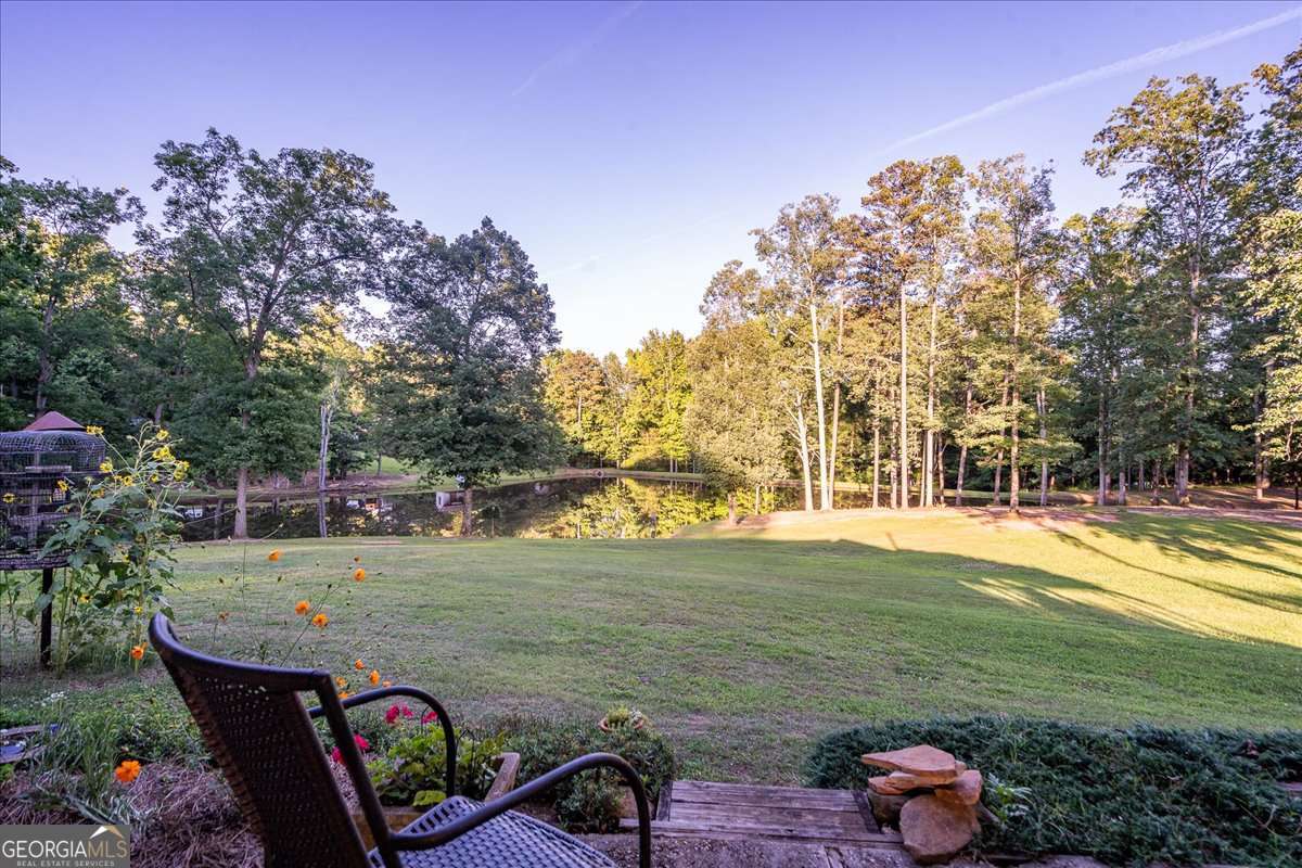 11302 Jefferson Road Athens, GA 30607 - Photo 28 of 75 a view of a wooden dinning table and chairs in the patio