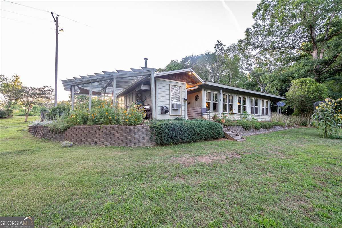 11302 Jefferson Road Athens, GA 30607 - Photo 51 of 75 a view of a house with a big yard and a large tree center in it