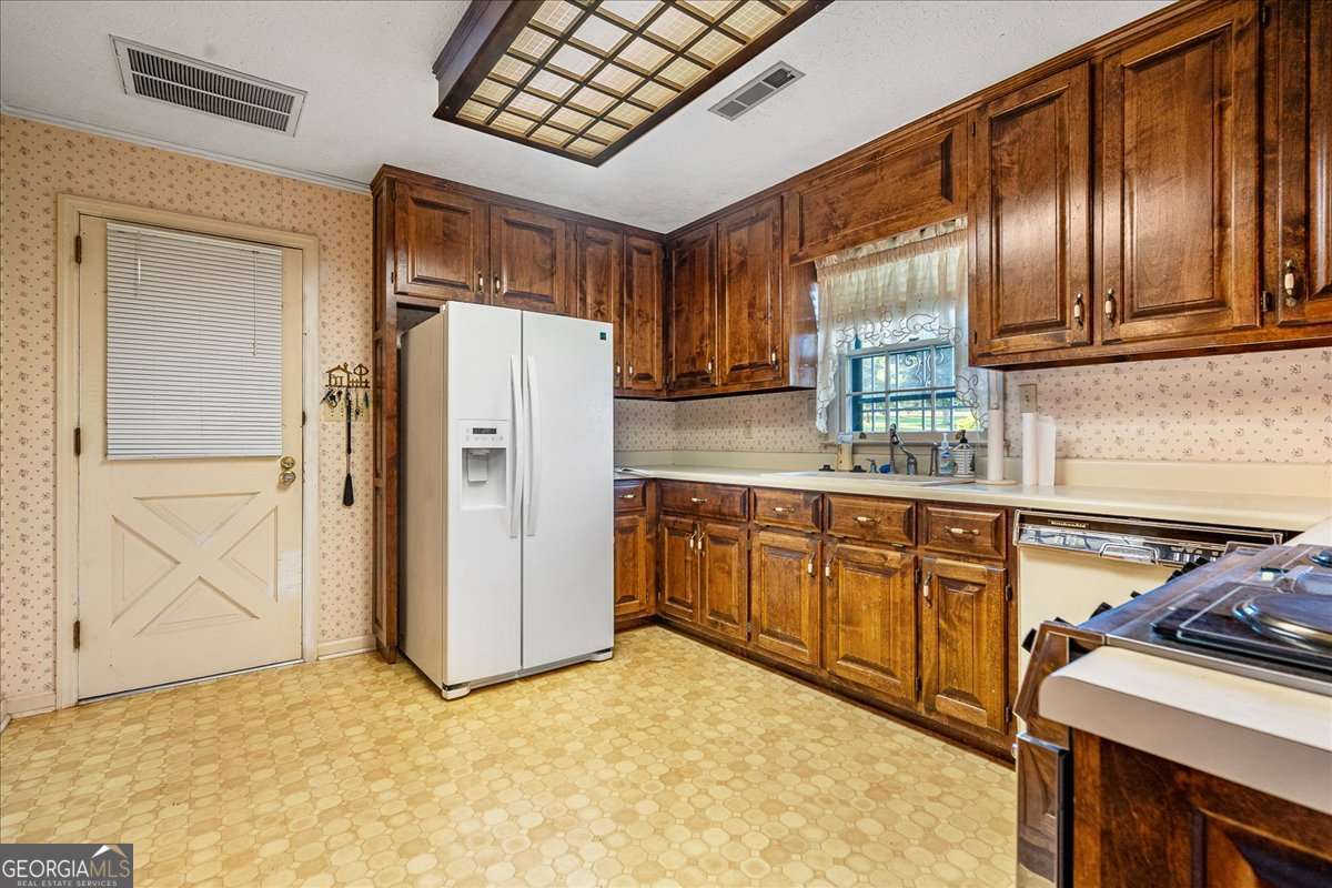 11302 Jefferson Road Athens, GA 30607 - Photo 7 of 75 a kitchen with stainless steel appliances granite countertop a refrigerator a stove and a sink with granite countertops