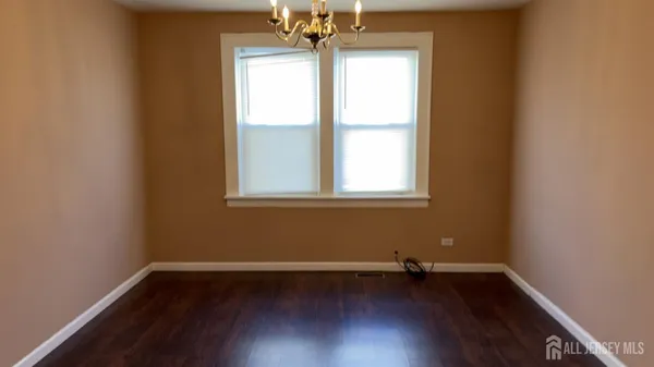 a view of a room with wooden floor and a window