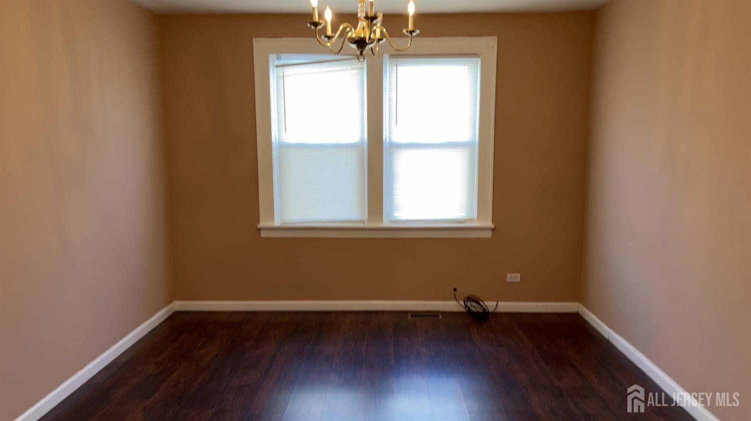 60 Heald Street, Unit F 1 Carteret, NJ 07008 - Photo 2 of 8 a view of a room with wooden floor and a window