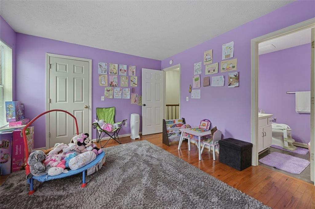 6420 Marbut Road Lithonia, GA 30058 - Photo 18 of 29 a bedroom with furniture and a floor to ceiling window